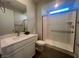 Modern bathroom with a large shower, toilet, and white vanity at 2110 Millergrove Ave, North Las Vegas, NV 89086