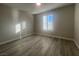 Light and airy bedroom with wood-look floors and plantation shutters at 2110 Millergrove Ave, North Las Vegas, NV 89086