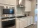 Modern kitchen with stainless steel appliances and white cabinets at 2110 Millergrove Ave, North Las Vegas, NV 89086