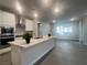 Open concept kitchen with island, stainless steel appliances, and white cabinets at 2110 Millergrove Ave, North Las Vegas, NV 89086