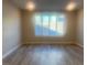 Living room with wood-look flooring and large window with shutters at 2110 Millergrove Ave, North Las Vegas, NV 89086