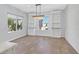 Bright dining room with hardwood floors, built-in shelving, and chandelier at 2236 Waterton Rivers Dr, Henderson, NV 89044