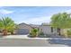 Single-story home with gray exterior, attached garage, and landscaped front yard at 2236 Waterton Rivers Dr, Henderson, NV 89044