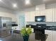 Modern kitchen with white cabinets, granite countertops, and stainless steel appliances at 2254 Cold Canyon Ave, North Las Vegas, NV 89086