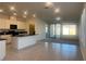 Open floor plan with modern kitchen and sliding glass doors to backyard at 2254 Cold Canyon Ave, North Las Vegas, NV 89086