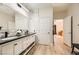 Updated bathroom with double vanity, marble accents, and a large mirror at 2401 Weaverville Dr, Henderson, NV 89044