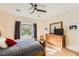 Comfortable bedroom featuring wood floors, a ceiling fan, and built-in dresser at 2401 Weaverville Dr, Henderson, NV 89044