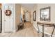 Light hardwood floors and decorative mirror in entryway at 2401 Weaverville Dr, Henderson, NV 89044