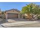 Single-story house with brown garage door and landscaped front yard at 2401 Weaverville Dr, Henderson, NV 89044