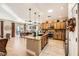 Kitchen with island, wood cabinets and granite countertops at 2401 Weaverville Dr, Henderson, NV 89044