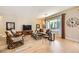 Living room with wicker furniture and view of backyard at 2401 Weaverville Dr, Henderson, NV 89044