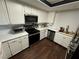 Modern kitchen with white cabinets, quartz countertops, and stainless steel appliances at 2477 Vallarta Cir, Las Vegas, NV 89121