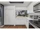 White kitchen with stainless steel appliances and a breakfast bar at 2477 Vallarta Cir, Las Vegas, NV 89121