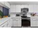 Modern kitchen featuring white cabinets, quartz countertops, and stainless steel appliances at 2477 Vallarta Cir, Las Vegas, NV 89121