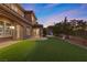 Artificial turf backyard with house and sunset view at 2717 Mona Lisa St, Henderson, NV 89044