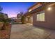 Backyard patio at dusk with artificial turf and landscape lighting at 2717 Mona Lisa St, Henderson, NV 89044