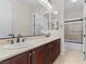 Double vanity bathroom with dark wood cabinets and a shower at 2717 Mona Lisa St, Henderson, NV 89044