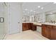 A full bathroom with double sinks, dark wood cabinets and a walk-in shower at 2717 Mona Lisa St, Henderson, NV 89044