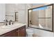 Bright bathroom with dark wood cabinets, and shower-tub combo at 2717 Mona Lisa St, Henderson, NV 89044