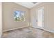 Bright, empty bedroom with natural light, travertine flooring, and a private door to the outside at 2717 Mona Lisa St, Henderson, NV 89044