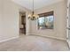 Formal dining room with a chandelier, large window, and built-in cabinetry at 2717 Mona Lisa St, Henderson, NV 89044