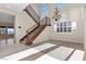 Elegant foyer showcases a staircase with decorative wrought iron and abundant natural light at 2717 Mona Lisa St, Henderson, NV 89044