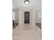 Inviting foyer featuring decorative tile inlay, neutral walls, and dark wood front door at 2717 Mona Lisa St, Henderson, NV 89044