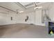 Spacious garage with epoxy flooring, overhead lighting, and white walls at 2717 Mona Lisa St, Henderson, NV 89044