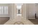 Hallway with decorative tile inlay, neutral walls, and light streaming in from nearby windows at 2717 Mona Lisa St, Henderson, NV 89044