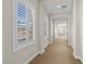 Hallway with neutral walls, carpet flooring, and shuttered windows overlooking the neighborhood at 2717 Mona Lisa St, Henderson, NV 89044