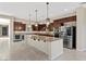 Spacious kitchen featuring large island, stainless steel appliances, and dark wood cabinetry at 2717 Mona Lisa St, Henderson, NV 89044