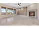 Bright living room featuring a fireplace, neutral walls, windows with views, and tile floors at 2717 Mona Lisa St, Henderson, NV 89044