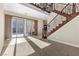 Elegant living room with staircase, chandelier, and sliding glass doors, blending indoor and outdoor spaces at 2717 Mona Lisa St, Henderson, NV 89044