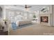 Staged main bedroom features a fireplace, ceiling fan, and a work area at 2717 Mona Lisa St, Henderson, NV 89044