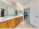 Double vanity bathroom with light wood cabinets and a view of the bedroom at 2744 Drummossie, Las Vegas, NV 89044