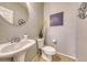 Small bathroom with pedestal sink, toilet, and decorative accents at 2744 Drummossie, Las Vegas, NV 89044