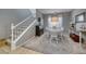 Bright dining room with white table and chairs, and view of staircase at 2744 Drummossie, Las Vegas, NV 89044