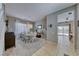 Formal dining room with white table and chairs, and view into living room at 2744 Drummossie, Las Vegas, NV 89044