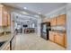 Open kitchen features granite counters, wood cabinets, and a view of the living area at 2744 Drummossie, Las Vegas, NV 89044