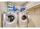 Functional laundry room with washer, dryer, and overhead shelving at 2744 Drummossie, Las Vegas, NV 89044