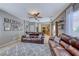 Open living area with leather sectional and view of kitchen at 2744 Drummossie, Las Vegas, NV 89044