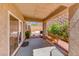 Relaxing covered patio with wooden swing and fire pit at 2744 Drummossie, Las Vegas, NV 89044