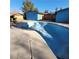 Blue kidney-shaped pool with visible wear and tear at 3011 Liberty Cir, Las Vegas, NV 89121