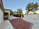 Landscaped backyard with a patio and rock features at 3012 Morning Ridge Dr, Las Vegas, NV 89134