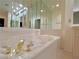 Relaxing bathtub with elegant gold fixtures in this bathroom at 3012 Morning Ridge Dr, Las Vegas, NV 89134