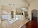 Kitchen with island, light wood cabinets and tiled floor at 3012 Morning Ridge Dr, Las Vegas, NV 89134