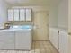 Laundry room with washer, dryer, and ample cabinet space at 3012 Morning Ridge Dr, Las Vegas, NV 89134