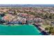 Stunning aerial view of waterfront homes nestled along a turquoise lagoon in a planned community with lush landscaping and terra cotta roofs at 3173 Lido Isle Ct, Las Vegas, NV 89117