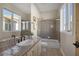 Bathroom featuring tiled countertops, tub with shower and large window at 3173 Lido Isle Ct, Las Vegas, NV 89117