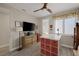 Bright bedroom featuring a ceiling fan, desk, television, and a light neutral color palette at 3173 Lido Isle Ct, Las Vegas, NV 89117